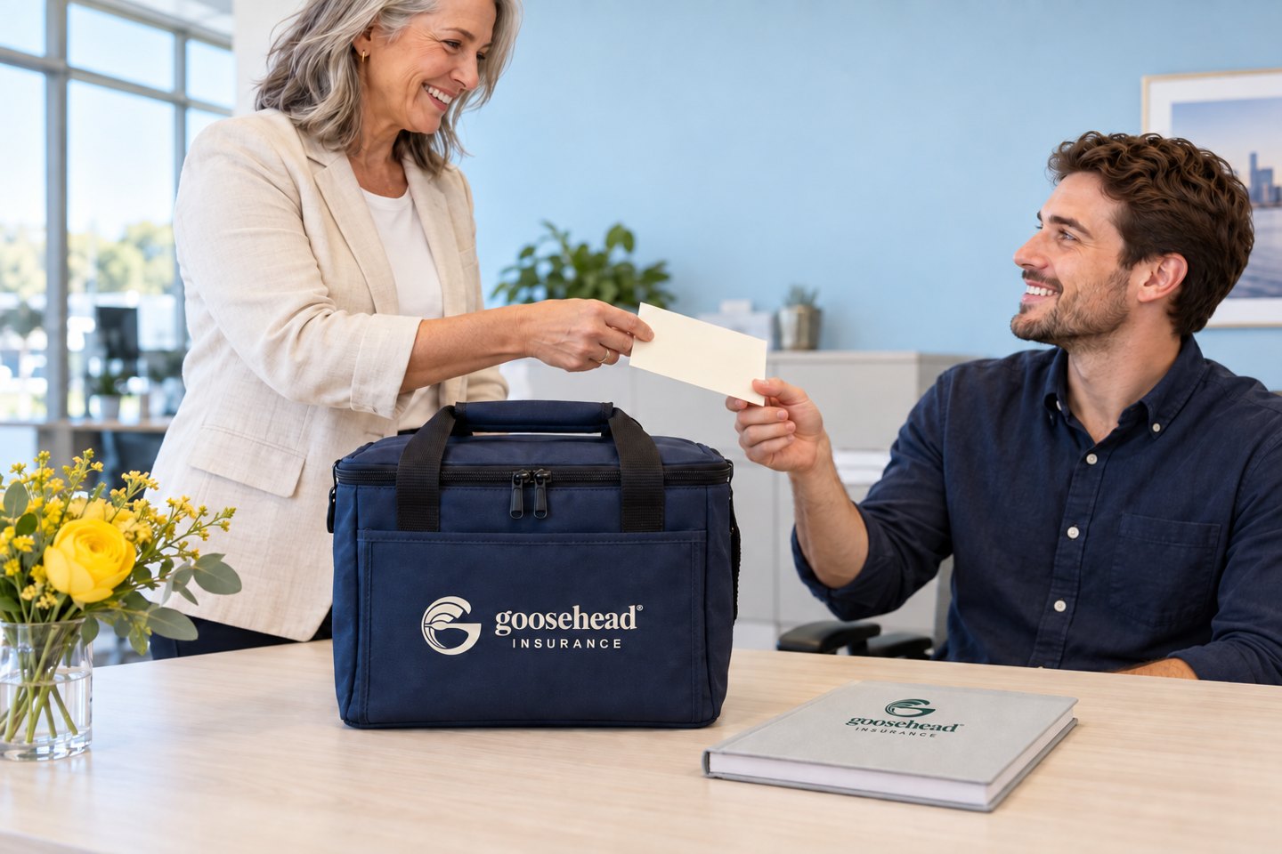 An employee thank-you with a lunch cooler branded on its front panel and a neatly printed notebook.
