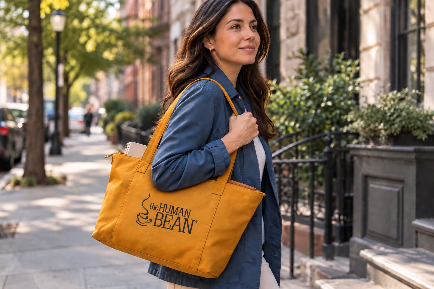 A person carrying a printed ochre tote on an everyday outing.